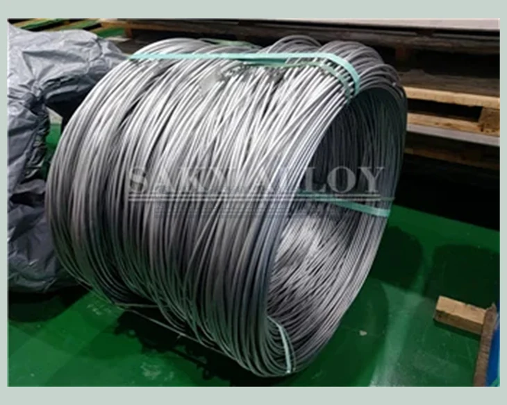 Coiled titanium wire bundle secured with green straps