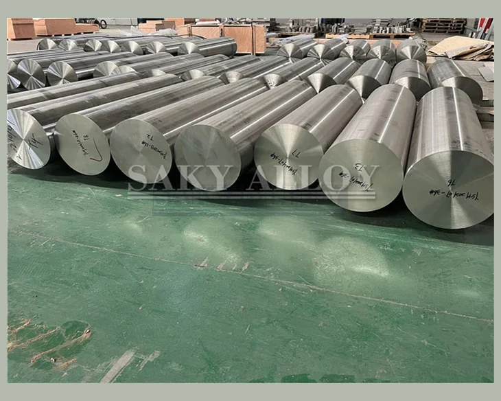 Large titanium round bars grouped on a workshop floor
