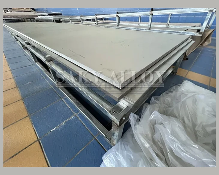 Large titanium plates stacked on a support rack