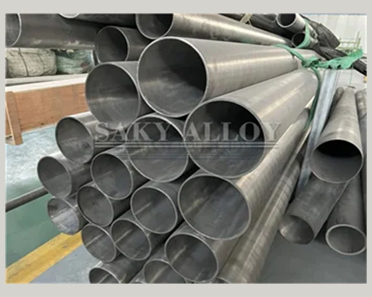 Large-diameter titanium pipes stacked in a workshop