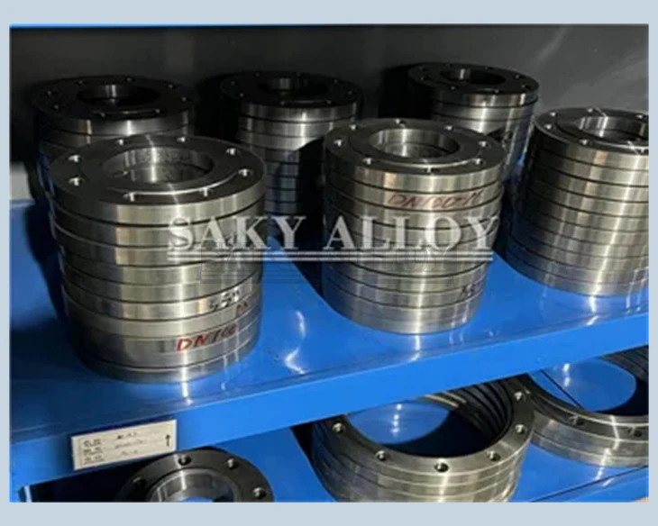 Stacks of machined titanium flanges on warehouse shelving