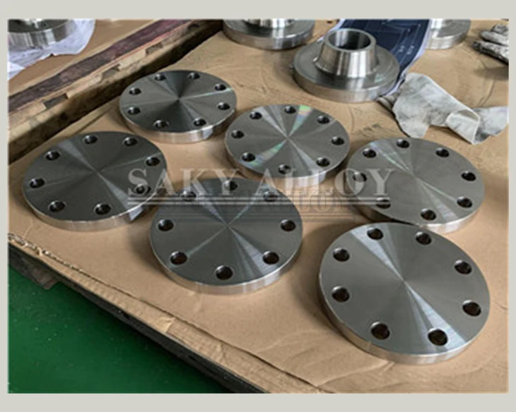 Titanium blind flanges arranged on protective cardboard