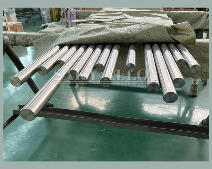 Bright-finished titanium round bars on a worktable
