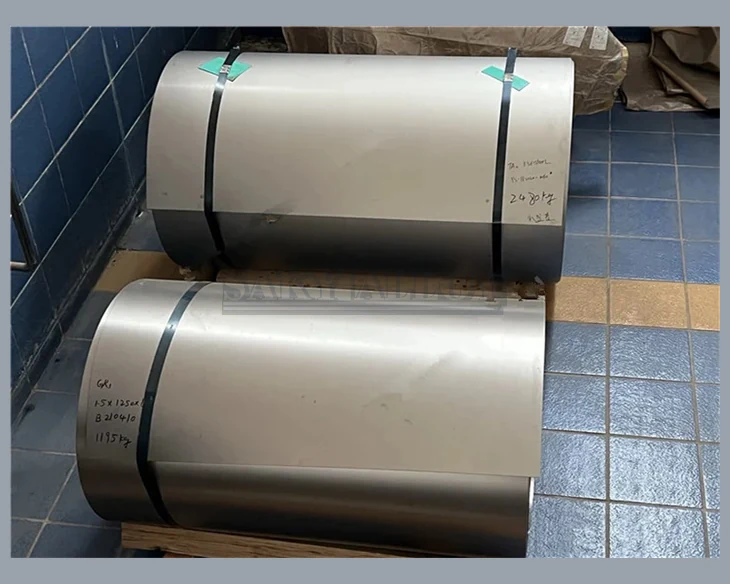 Two wide titanium coils secured on pallets